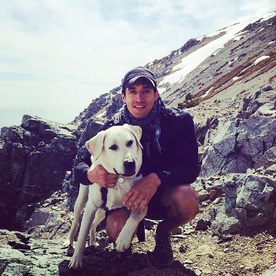 Photo of Keahu Kahuanui and his  Labrador Retriever. 